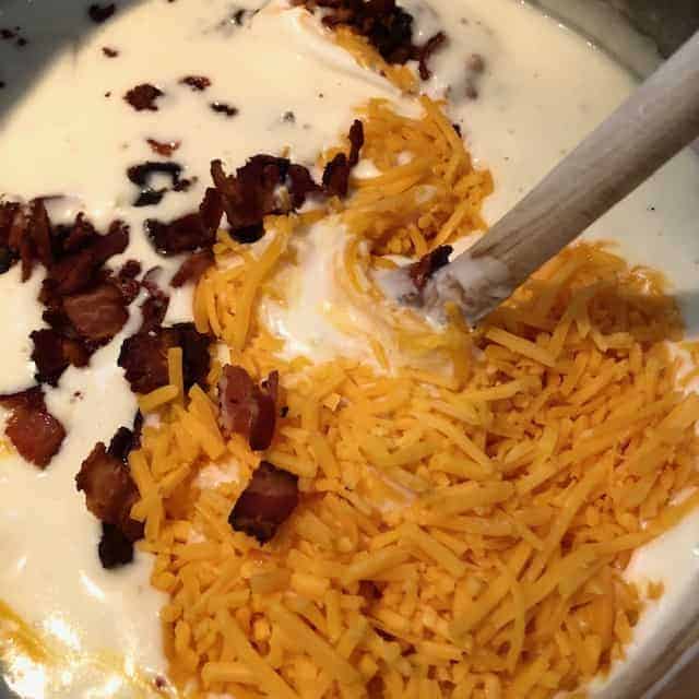 Baked Potato Soup Stirring In Ingredients