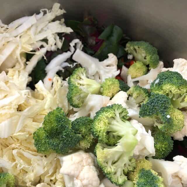 adding veggies in pot