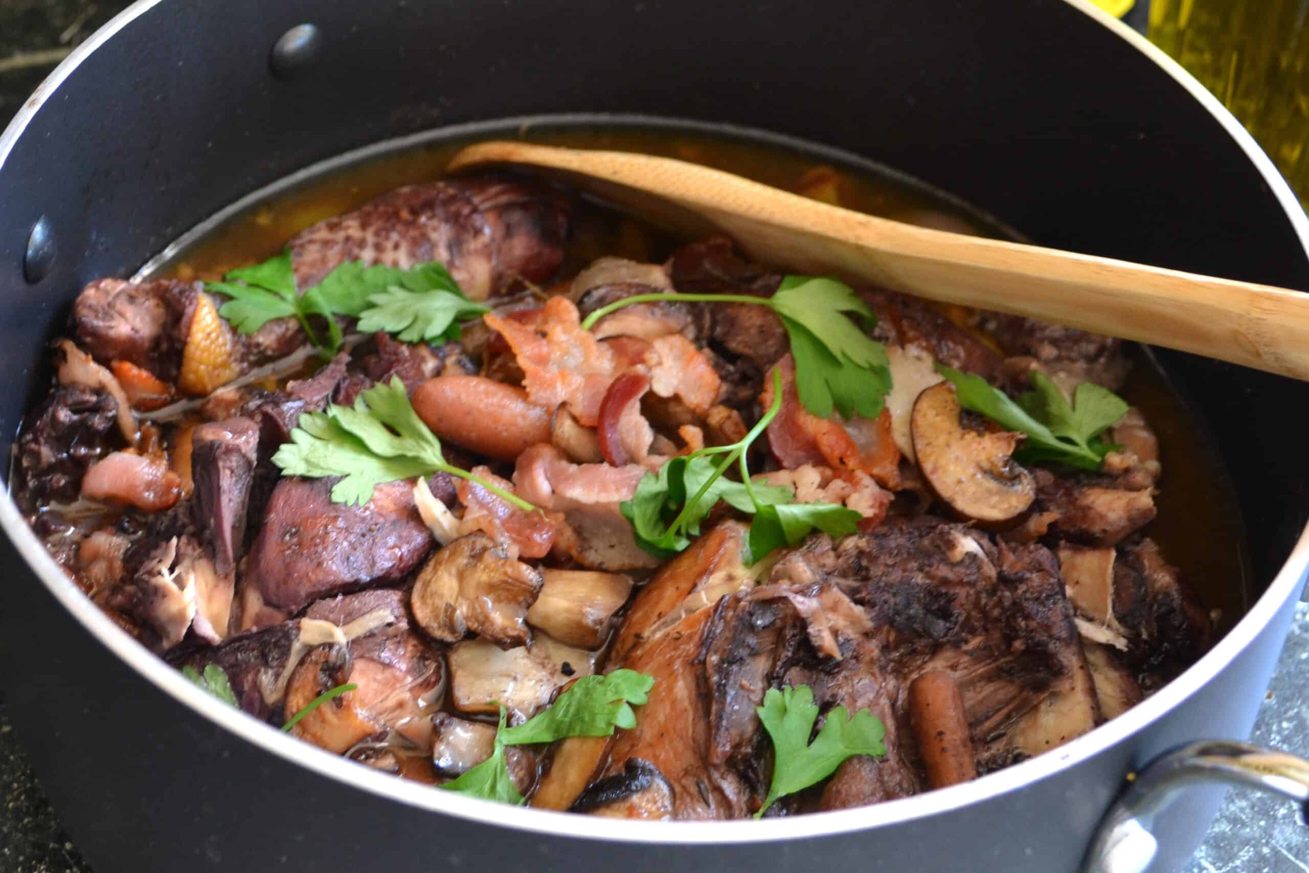 Coq au Vin – Classic French Chicken in Red Wine Sauce Coq au Vin in a Dutch oven – French braised chicken in red wine with bacon, mushrooms, and pearl onions.