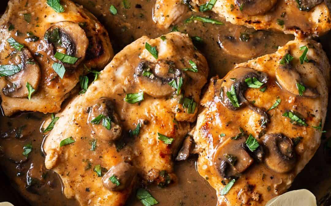 Pan-seared Chicken Marsala topped with mushrooms and parsley in a creamy Marsala wine sauce.